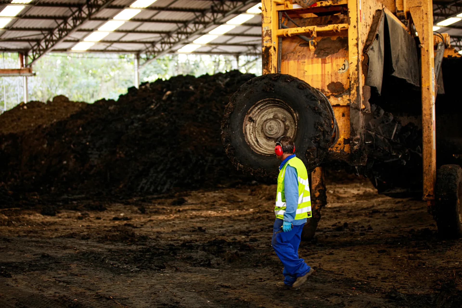 Operator beside a composting machine at Tera Ambiental